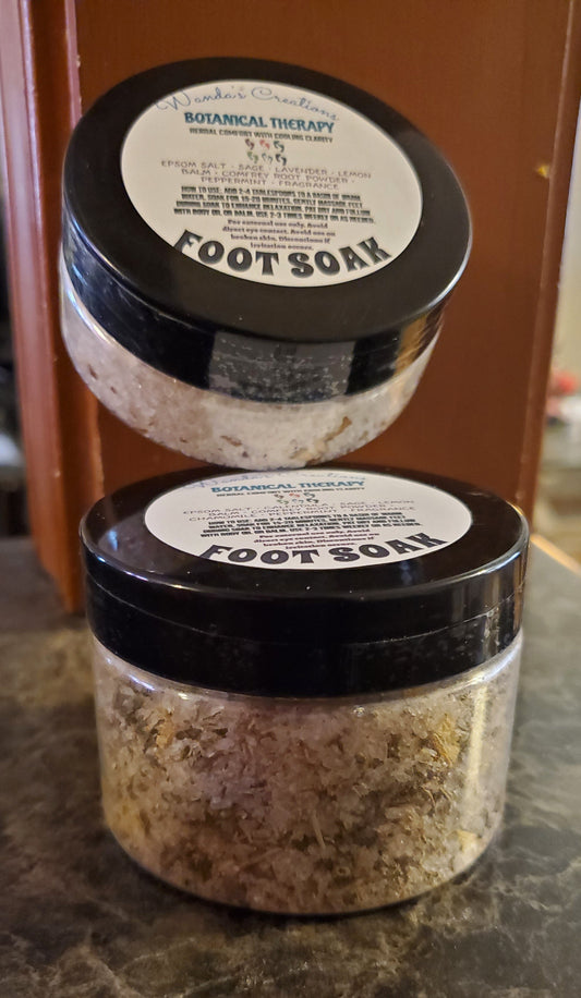 Two jars of foot soak on a marble surface with a blurred background