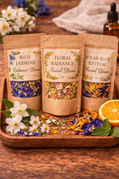 Three facial steam packages labeled 'Blue Jasmine', 'Floral Radiance', and 'Solar Blue Revival' on a wooden tray with flowers and an orange.
