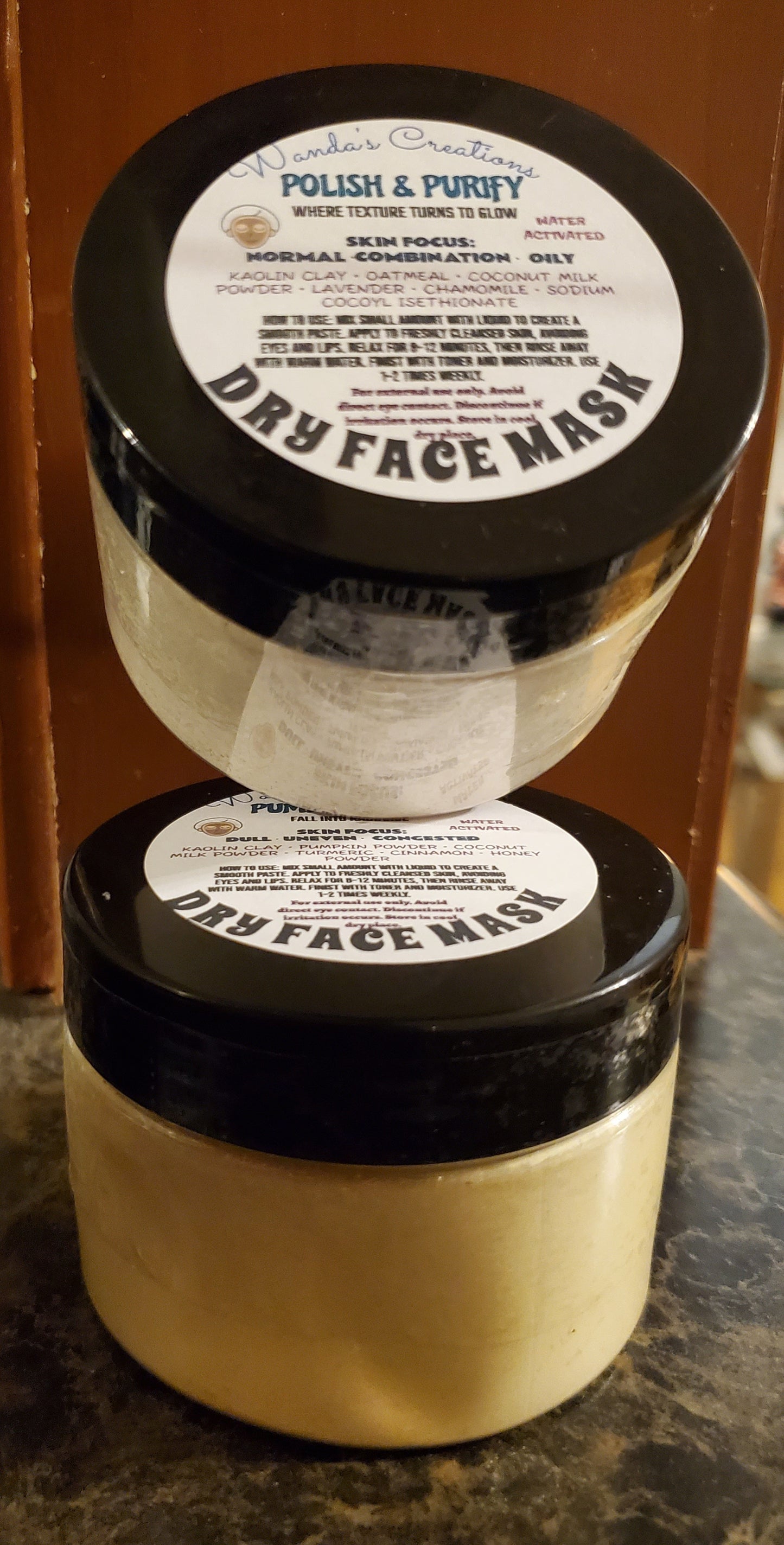 Two containers of Polish & Purify Dry Face Mask on a wooden surface.