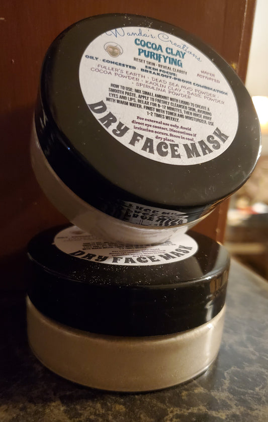 Two containers of Dry Face Mask with labels on a marble surface.